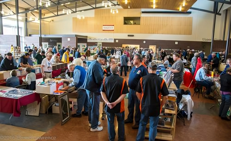 People browsing tables at a busy convention.