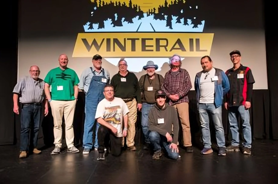 Group of people at Winterail event stage.