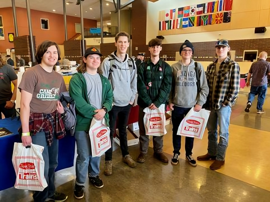 Group of people holding shopping bags indoors.