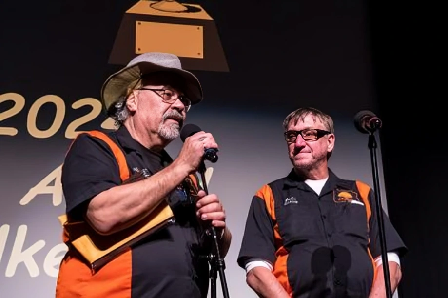 Two men speaking at an award event.